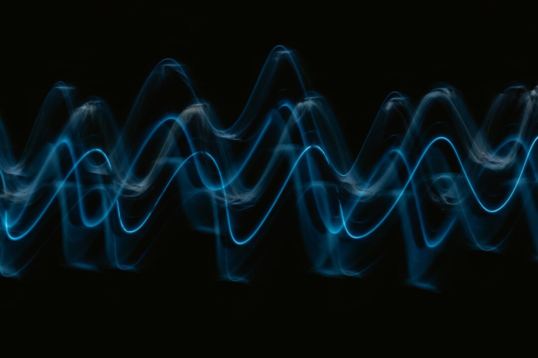 Blue stylized sound waves on a black background.