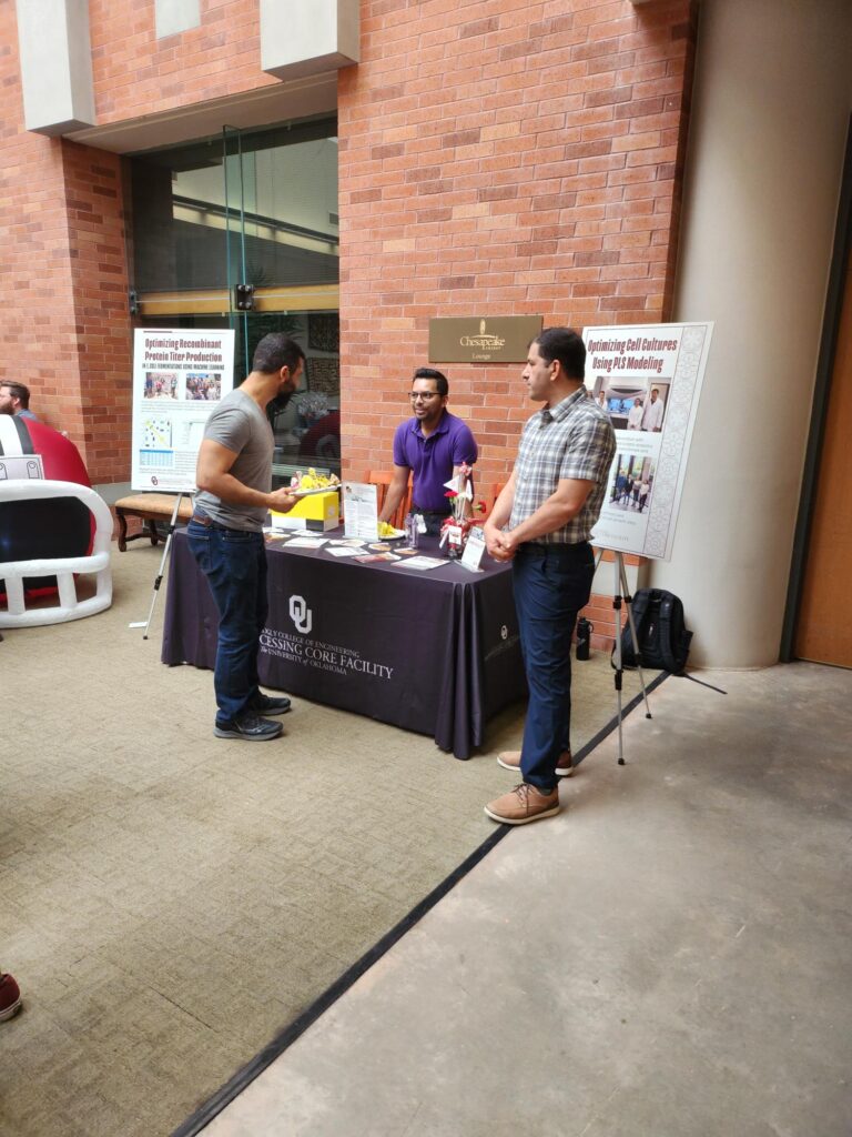 Student interacting with Bioprocessing Core Facility information booth.