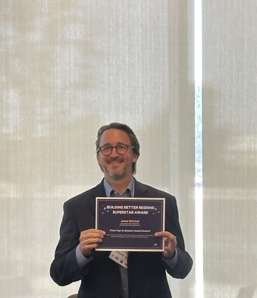 COE OF WHEELER BIO, JEESE MCCOOL
HOLDING HIS BUILDING BETTER REGIONS SUPERSTART AWARD.